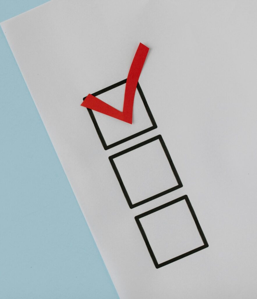 A simple white paper checklist with one red checkmark, ideal for concepts like completion or approval.